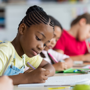 young girl writing on paper